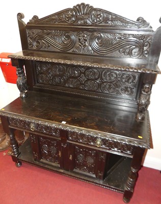 Lot 1154 - An ebonised oak and relief carved buffet side...