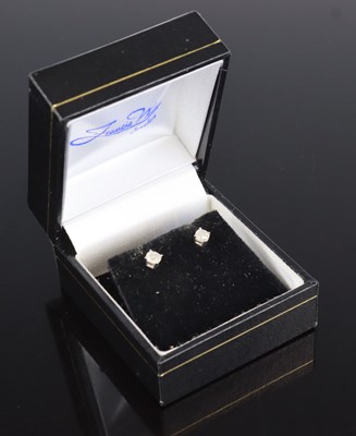 Lot 290 - A pair of 14k diamond earstuds, the round...