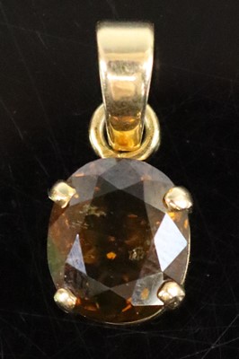 Lot 311 - A 9ct gold brown zircon pendant, the zircon...
