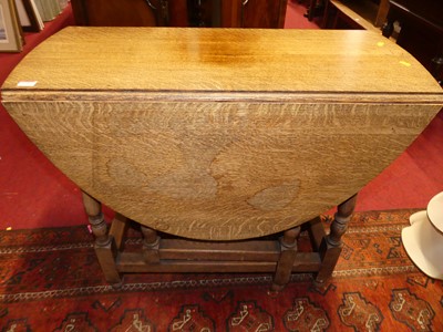 Lot 1191 - An early 20th century oak dropleaf gateleg...