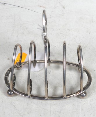 Lot 214 - An Edwardian silver four division toast rack...