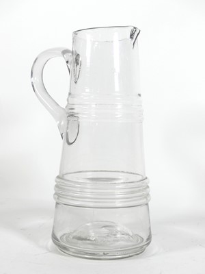 Lot 33 - A hand blown glass jug, of tapered and banded...