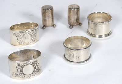 Lot 232 - A group of four silver napkin rings, together...