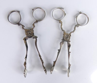 Lot 2130 - Two pairs of George III silver sugar nips,...