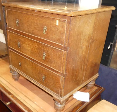 Lot 1168 - A small oak squarefront chest of three long...