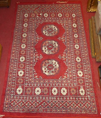 Lot 1183 - A Persian woollen red ground Bokhara hall...