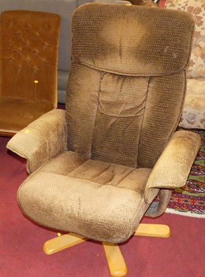 Lot 1362 - A contemporary fabric upholstered swivel...