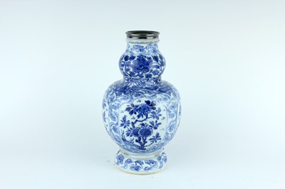 Lot 46 - A Chinese blue and white gourd vase, Qing...