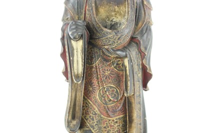 Lot 44 - A Chinese lacquered wooden figure of a deity,...