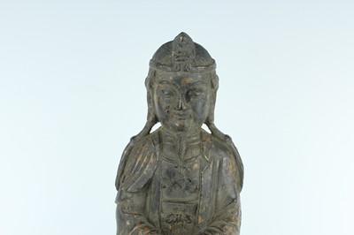 Lot 65 - A Chinese bronze figure of a seated...