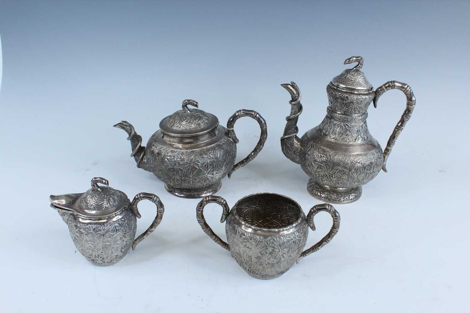 Lot 159 - A set of four Chinese export silver tea sets,...