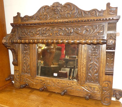 Lot 1187 - An early 20th century floral relief carved oak...