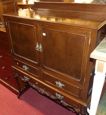 Lot 1319 - A walnut double door side cabinet on stand,...