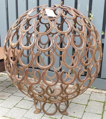 Lot 1445 - A sculptural metal horseshoe sphere, height...