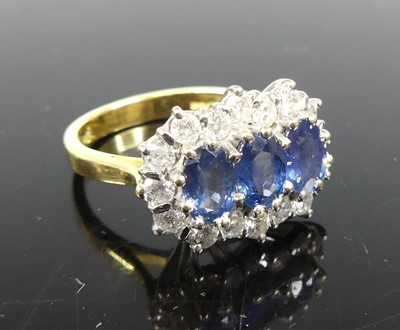 Lot 2266 - An 18ct yellow and white gold sapphire and...