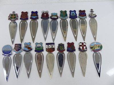Lot 37 - A collection of white metal souvenir clip...