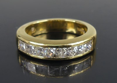 Lot 2579 - An 18ct yellow gold diamond half eternity ring,...