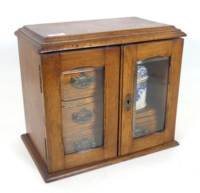 Lot 95 - A Victorian oak smoker's cabinet, having a...