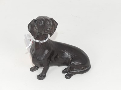 Lot 318 - A contemporary bronzed model of a dachshund in...