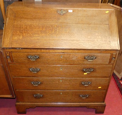 Lot 1179 - A George III provincial oak slopefront four...