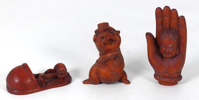 Lot 230 - A netsuke in the form of a face within an...
