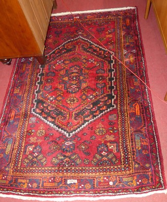 Lot 1340 - A Persian woollen red ground Qashqai rug, 202...