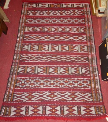 Lot 1333 - A Persian woollen red ground hall runner...