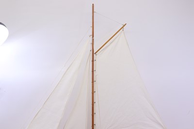 Lot 57 - A carved wooden hull pond yacht, with canvas...