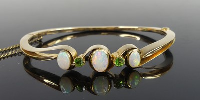 Lot 2173 - A yellow metal, garnet and opal hinged hollow...