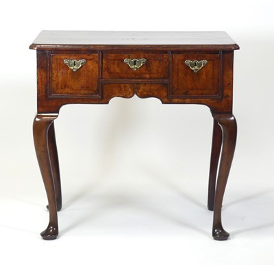 Lot 2456 - A George II walnut lowboy, the four-quarter...