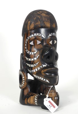 Lot 12 - A carved hardwood and paua shell inlaid...