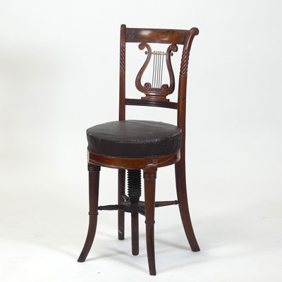 Lot 2402 - A circa 1830 rosewood music chair, having a...