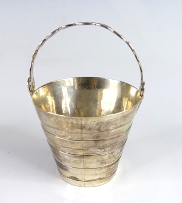Lot 2074 - A George II silver gilt swing-handled table...