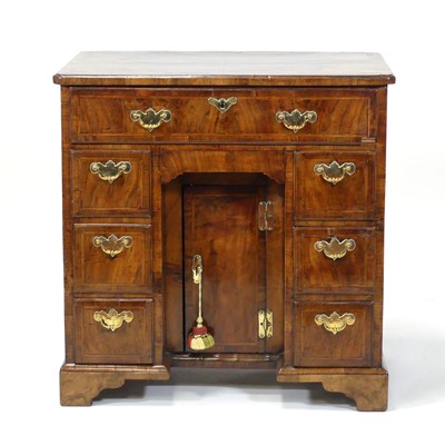 Lot 2468 - A George II walnut and figured walnut kneehole...