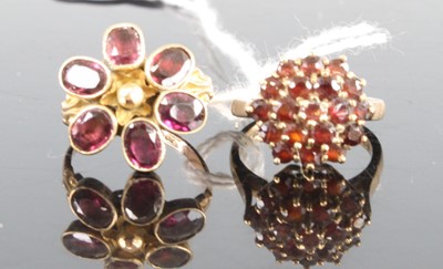 Lot 404 - Two garnet rings, being a 9ct yellow gold...