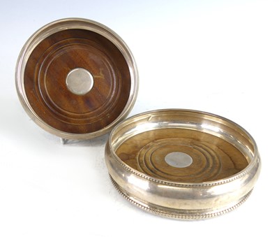 Lot 2150 - Two Elizabeth II silver wine bottle coasters,...