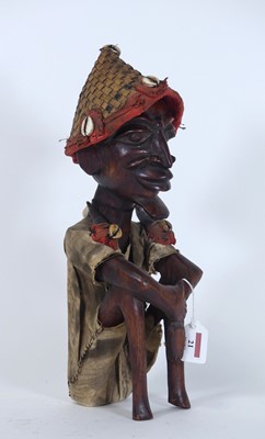 Lot 21 - An African carved hardwood figure, modelled...