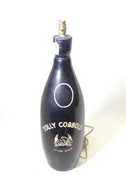 Lot 113 - A black painted glass bottle, of large...