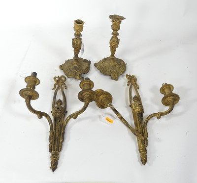 Lot 144 - A pair of gilt brass table candlesticks, in...
