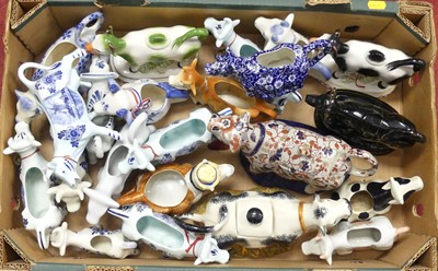Lot 155 - A collection of pottery cow creamers, to...