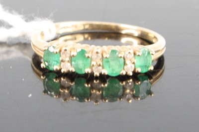 Lot 423 - A 9ct gold, emerald and white sapphire set...