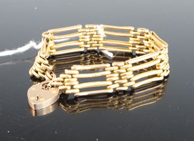 Lot 437 - A 9ct gold gatelink bracelet, with heart...