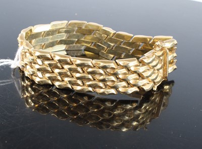 Lot 439 - A modern 9ct gold bracelet, as five interwoven...