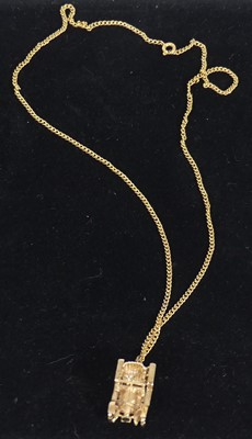 Lot 440 - A single 9ct gold charm fashioned as a vintage...