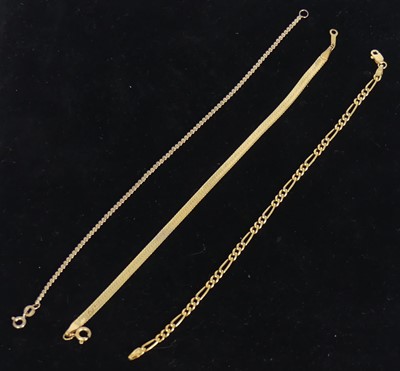 Lot 446 - Three modern 9ct gold bracelets, to include a...