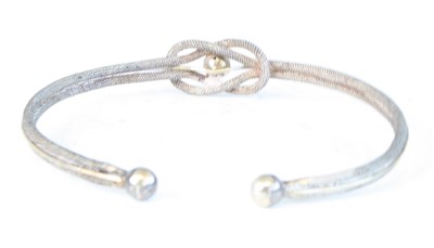 Lot 490 - A silver and engraved hinge bangle with safety...