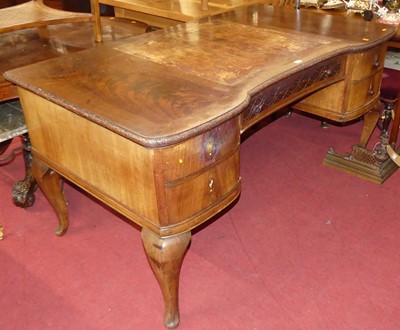 Lot 1278 - A mahogany kneehole writing desk, having a...