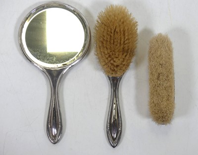 Lot 244 - A silver-clad three-piece dressing table set,...