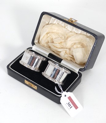 Lot 301 - A pair of George VI silver napkin rings, each...