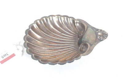 Lot 305 - A George V silver butter dish of shell shape...